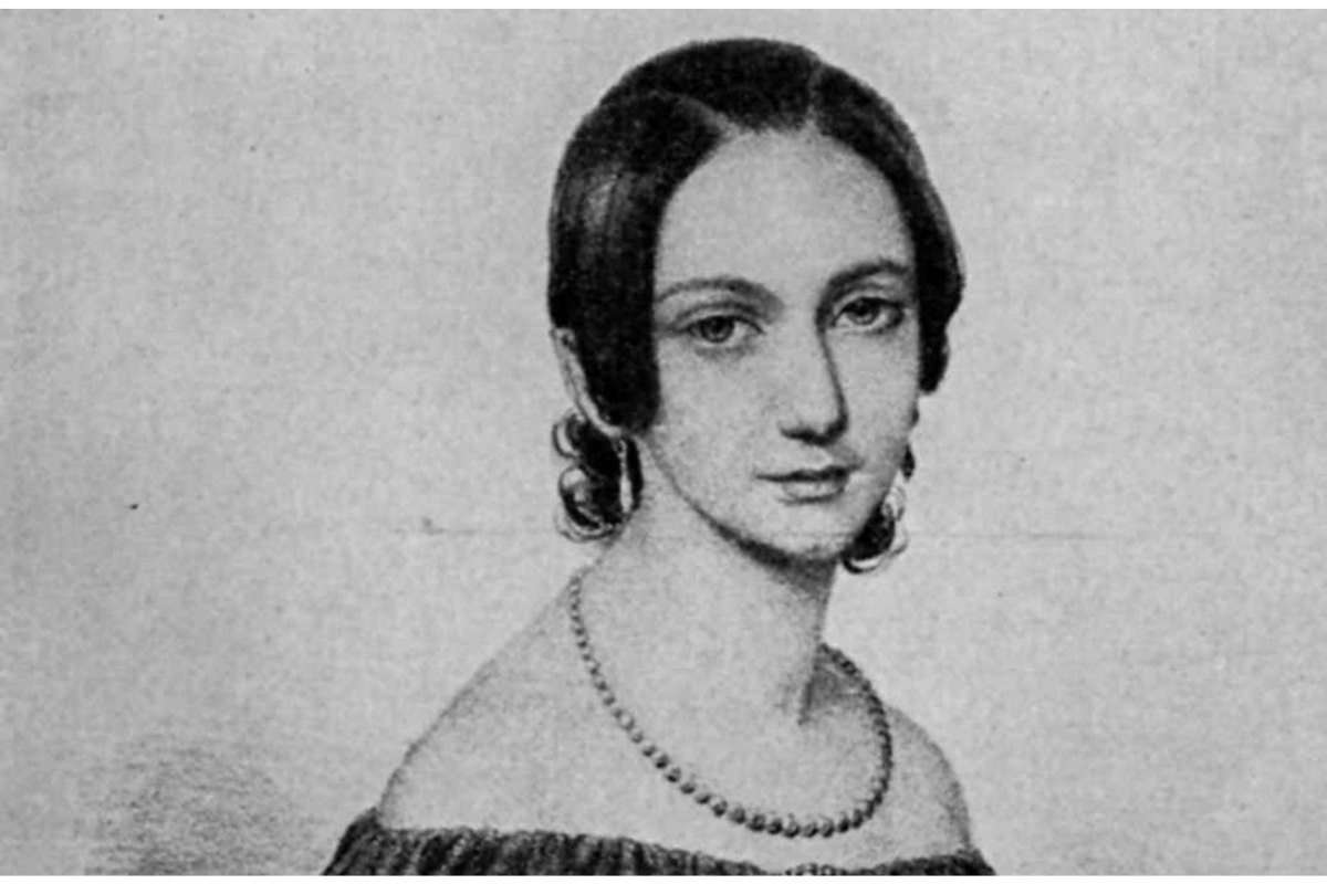 Black-and-white portrait of woman wearing necklace and earrings