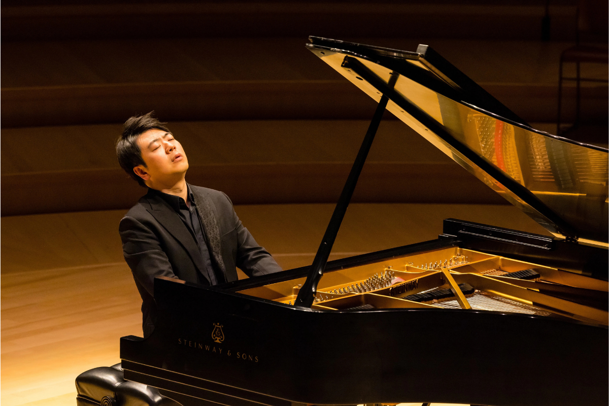 Pianist performing passionately on grand concert stage