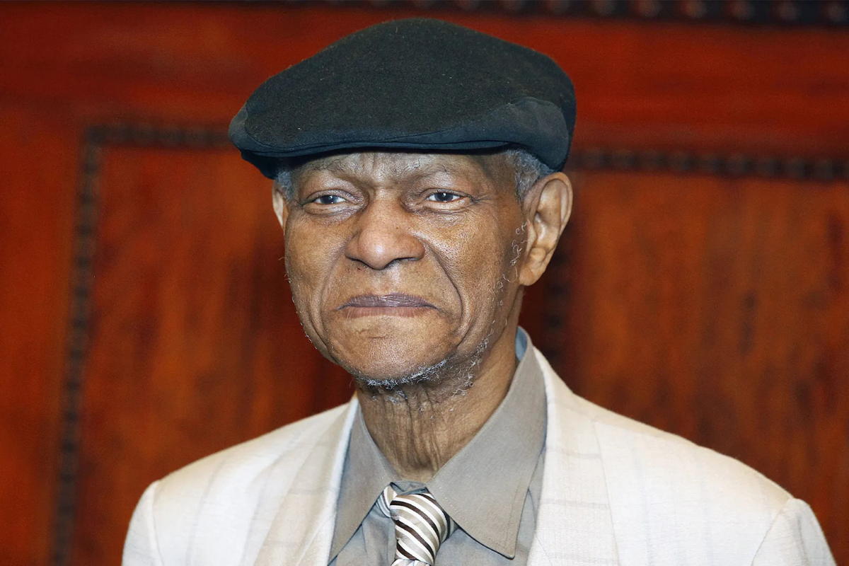 Elderly man wearing flat cap and striped tie
