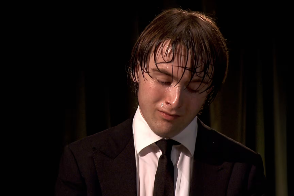 Sweaty pianist in suit after intense performance