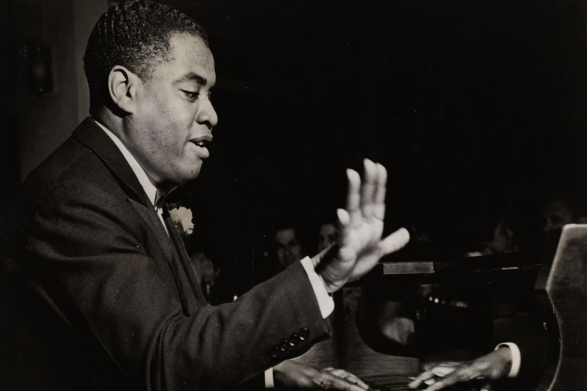 Jazz pianist performing energetically during live concert