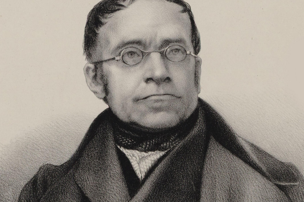 Black-and-white portrait of bespectacled man in formal attire