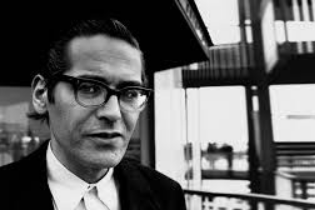 Man wearing glasses standing inside modern building interior